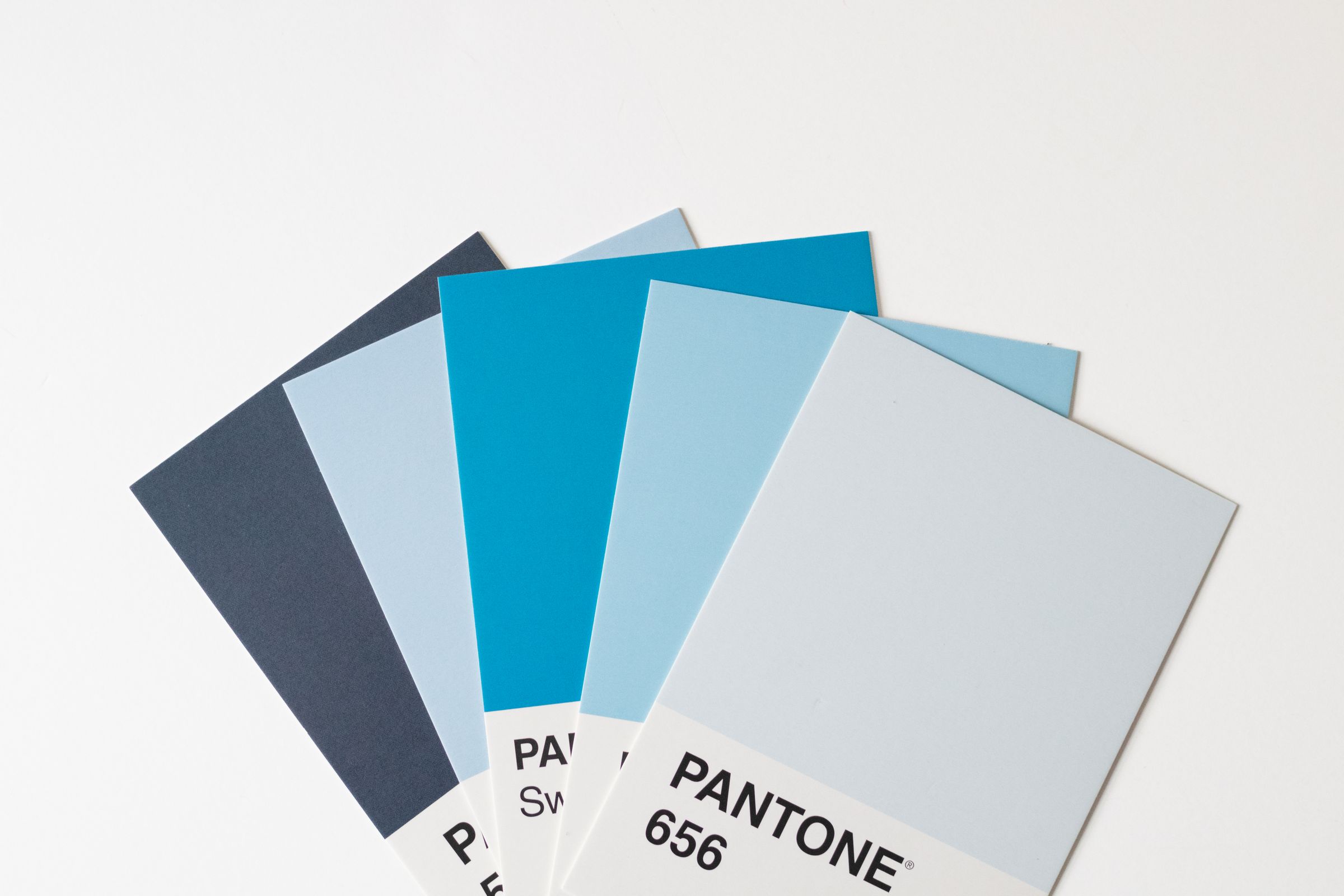 Fanned Pantone colour chips in shades of blue