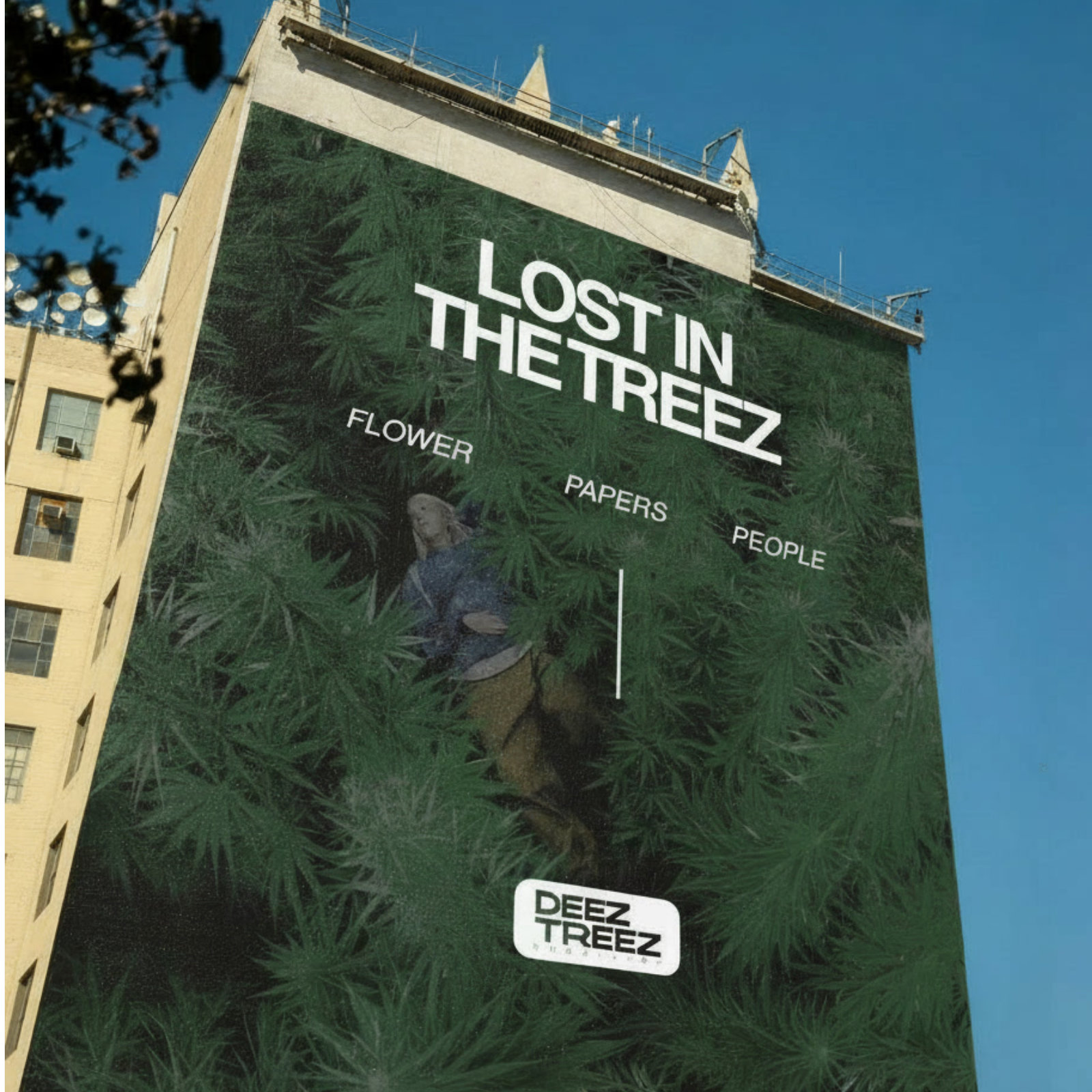 Building-sized mural reading Lost in the Treez, with a person lying in cannabis leaves and the Deez Treez logo