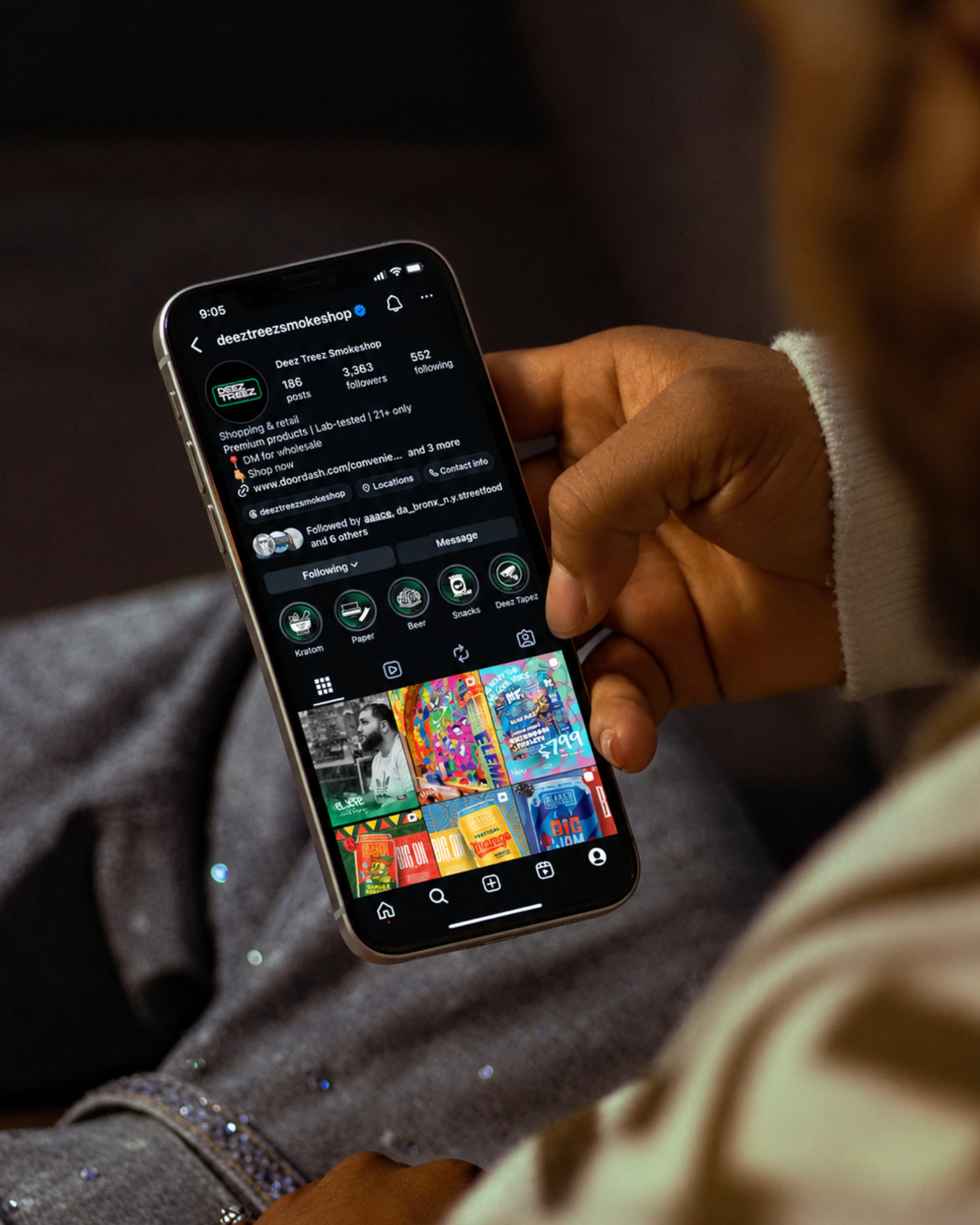 A hand holding a phone showing the Deez Treez Smokeshop Instagram profile